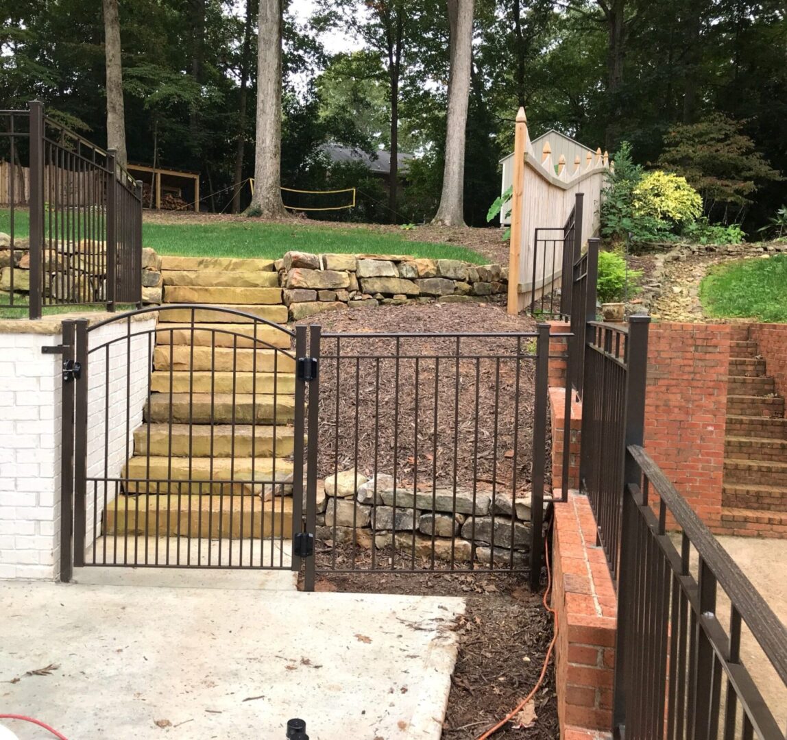 A view of a fence and steps from the ground up.